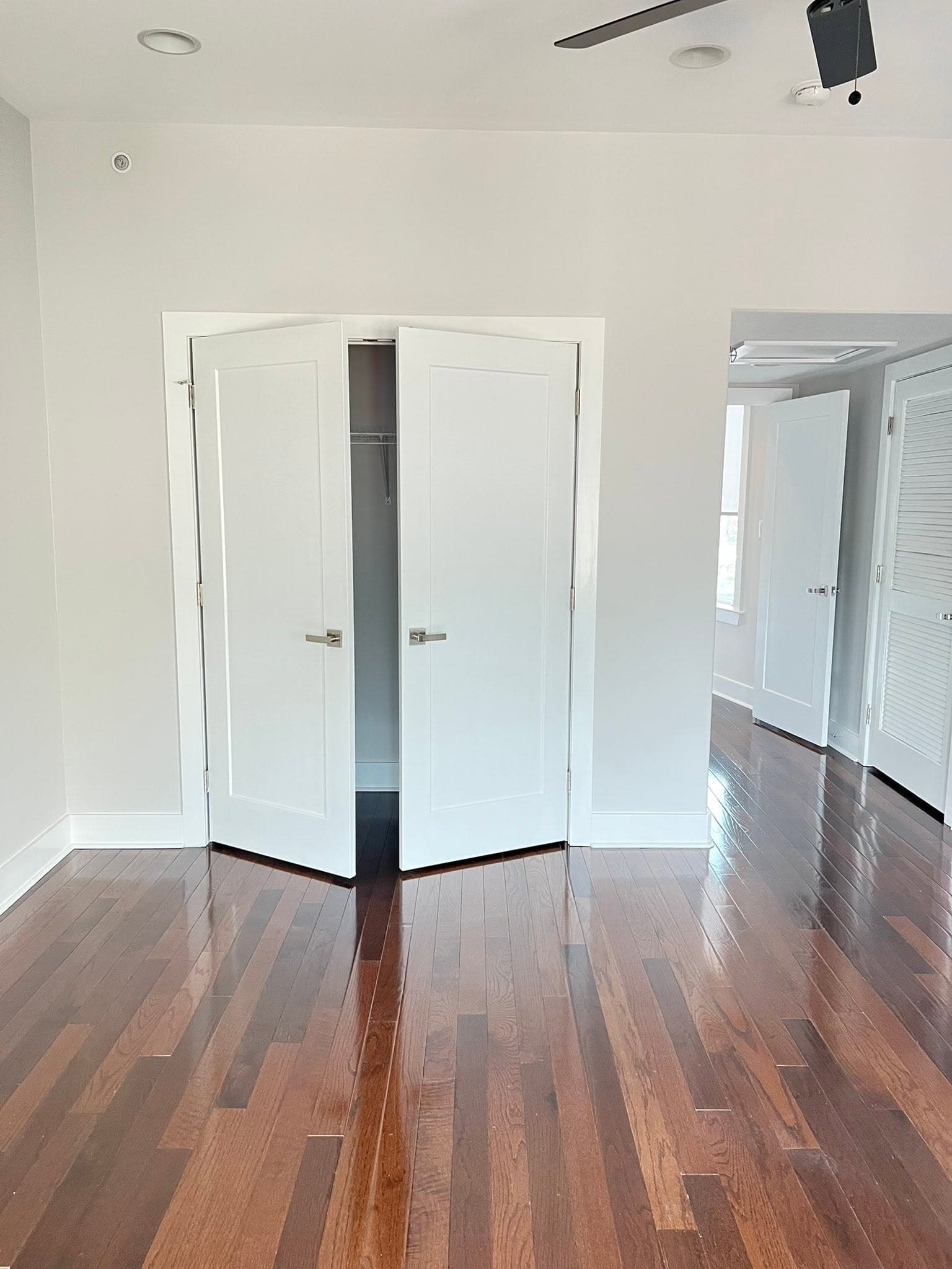 Light-painted interior with dark wood flooring, after view 2