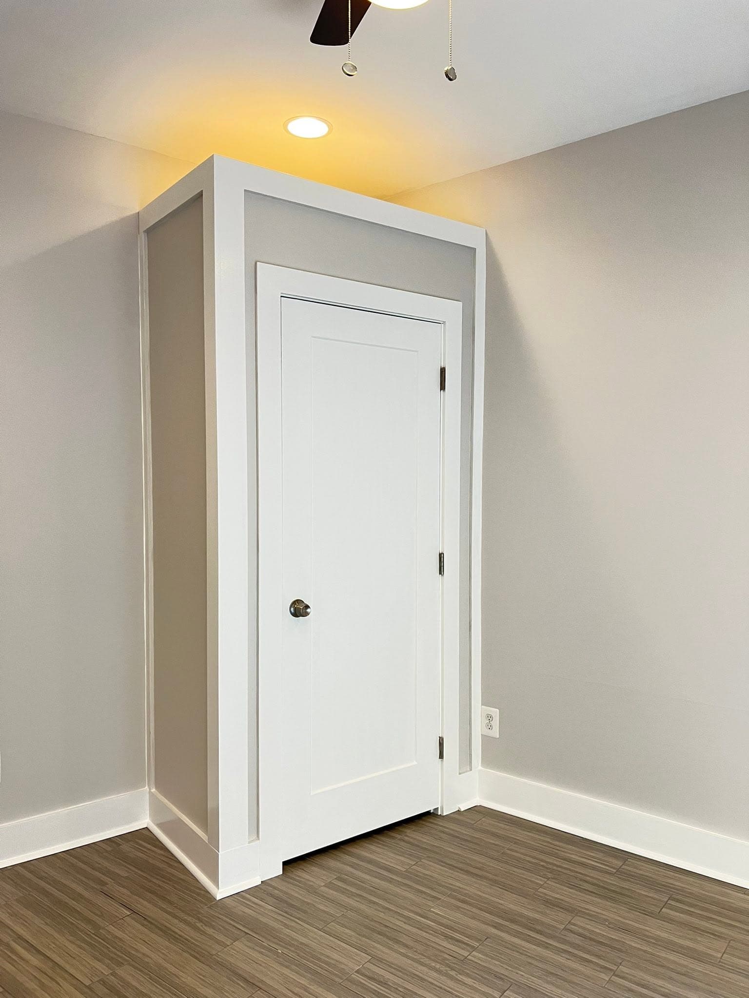 Light-painted interior with dark wood flooring, after view 6