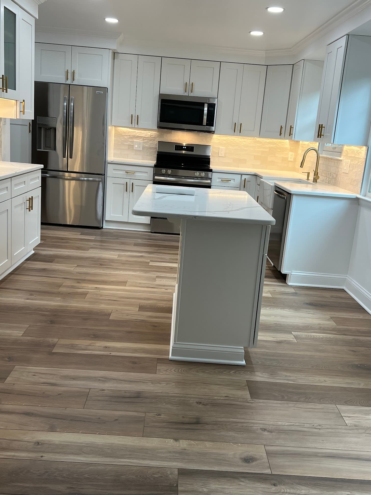 Kitchen with white cabinetry, after view 4