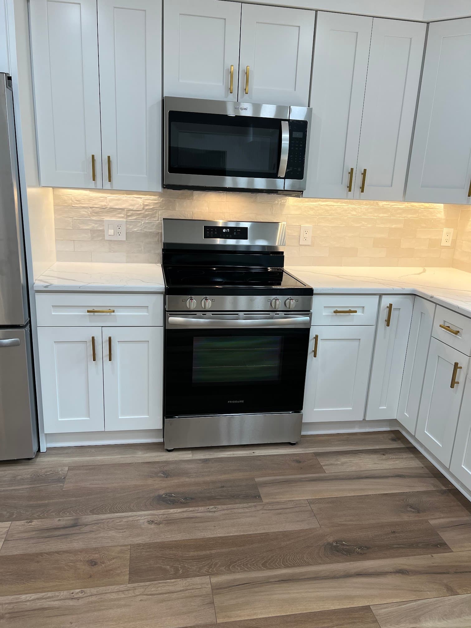 Kitchen with white cabinetry, after view 5