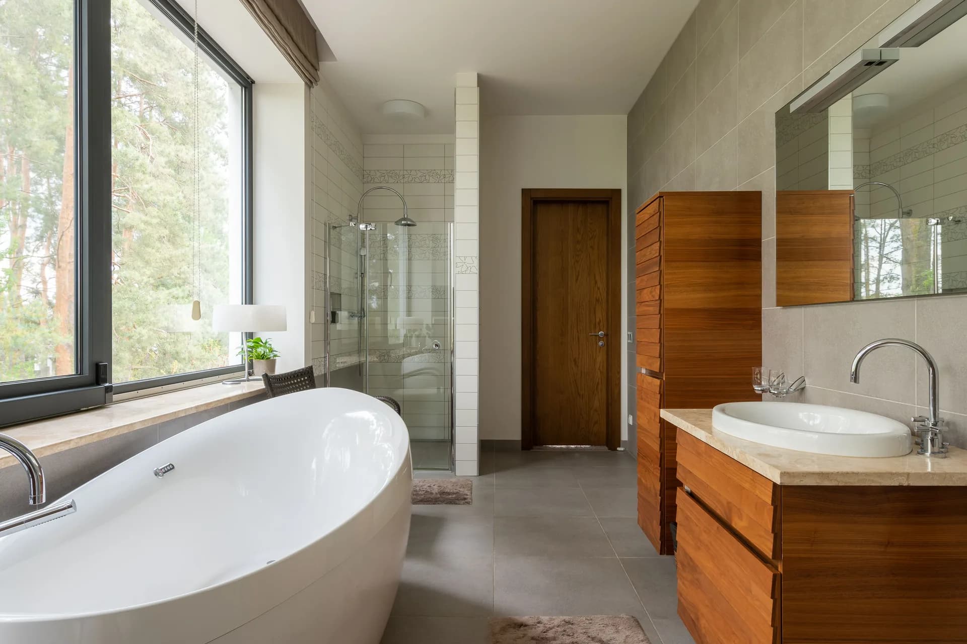 Modern bathroom with a freestanding tub and large window