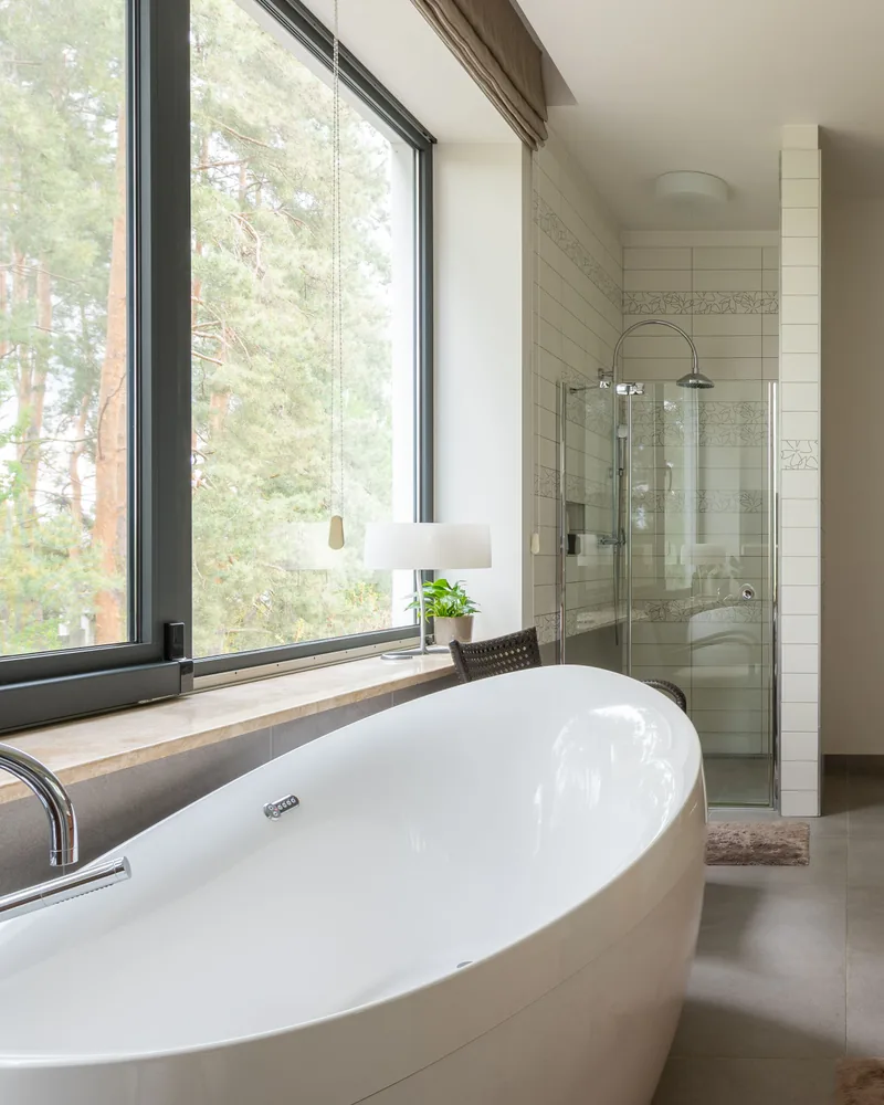 Modern bathroom with a freestanding tub and large window