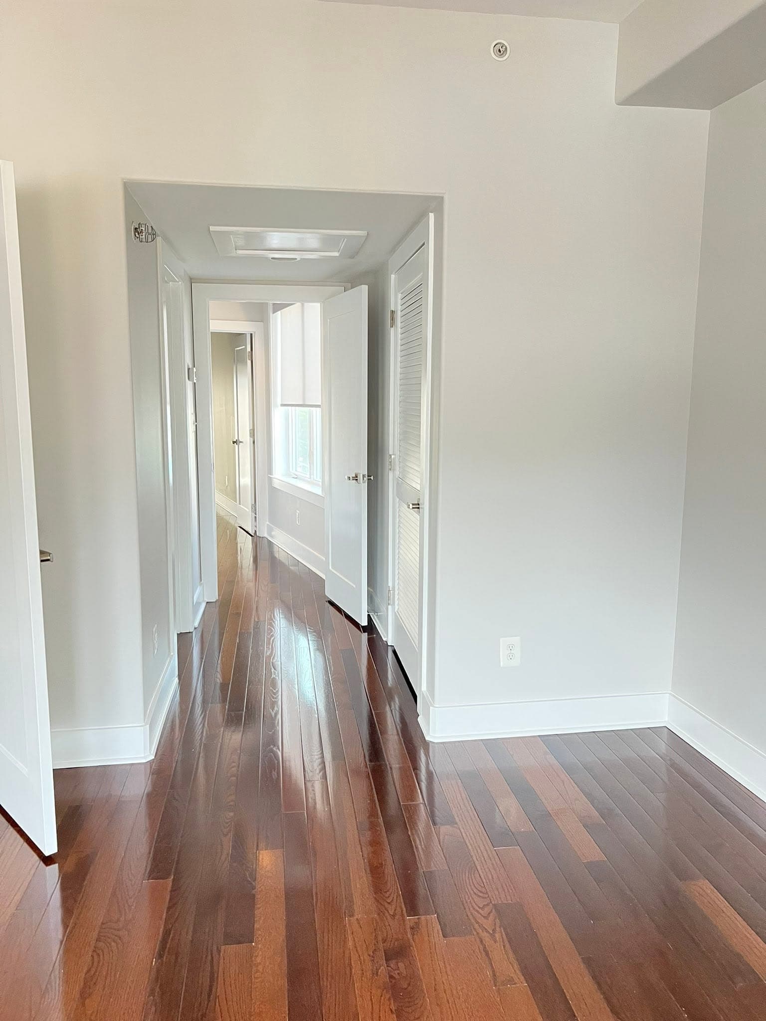 Light-painted interior with dark wood flooring, after view 1